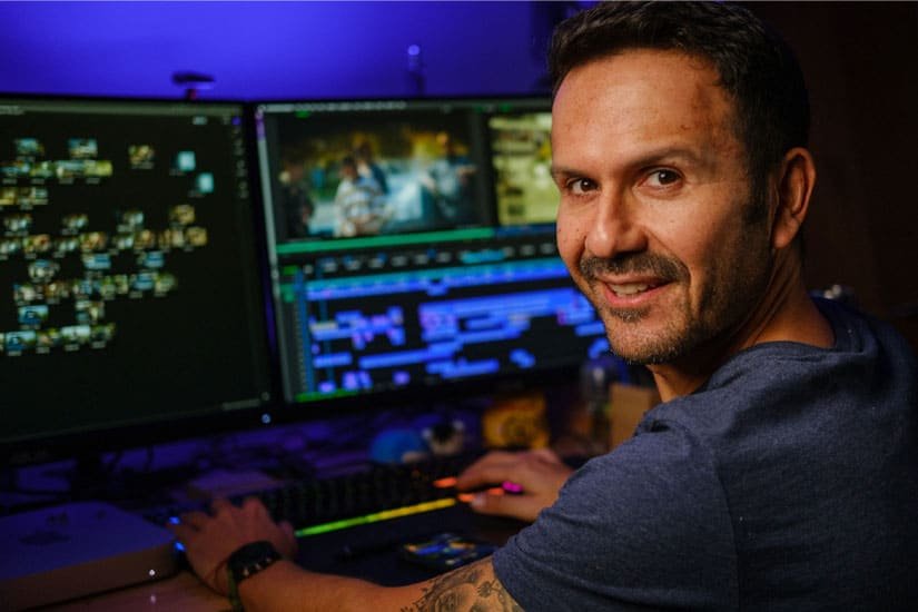 Joaquin Elizondo editing video on a computer